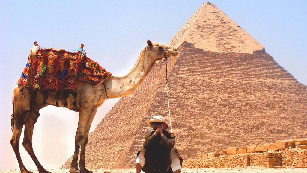 https://pixabay.com/photos/camel-desert-pyramid-middle-east-926435/