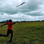 Agritech: Patrick Kalonde, one of the drones pilots, stands beneath the drone as it takes off in the Kasungu district in Malawi. May 30, 2020. Photo: Thomson Reuters Foundation/ Handout via Kennedy Zembere for Malawi Liverpool Wellcome Trust