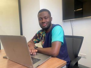 Data cost: Tech developer Divine Pumplampu poses from his office with his laptop under his arm in Accra, Ghana. Photo: Thomson Reuters Foundaton/Kent Mensah