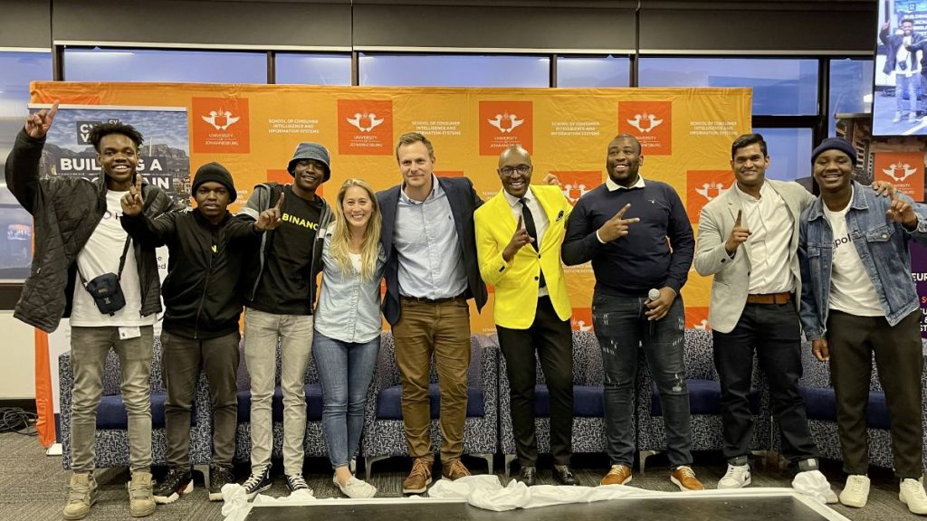 “Hackchain” winning team with Ronny Mabokela of the University of Johannesburg (fourth from right), Gideon Greaves CV Labs Africa (centre), Lucky Litelu, (third from right) Brenton Naicker CV Labs (second from right), Chloe Sanham of Polygon (sixth from right). Photo: Supplied/Ventureburn