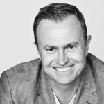 Black and white headshot of Melon Mobile CEO, Calvin Collett, smiling